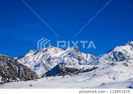 Winter landscape with mountains covered snow under blue sky in cold sunny day 118841839