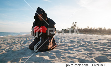 The Boxer Monk Praying With Gloves  118948060