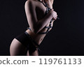 Photo of woman covered breast in black bdsm belt 119761133