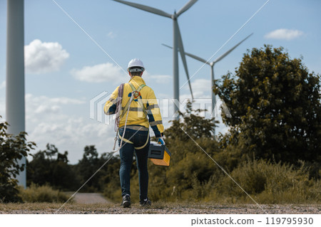 Man engineers holding tools box and rope to maintenance working in wind turbine. Renewable energy power wind turbine. Technology protect environment reduce global warming problems. 119795930