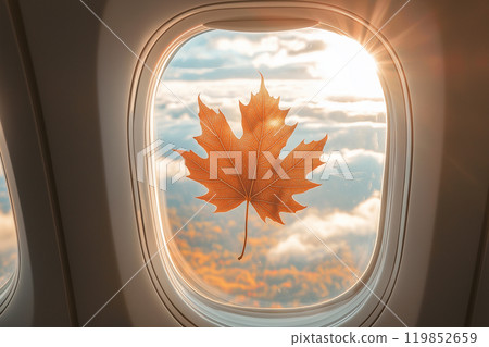 Autumn fallen maple leaf stuck on the window of an airplane. Autumn travel and flights, autumn season. Top places to travel in Fall season. Canada travel, seasonal tourism 119852659