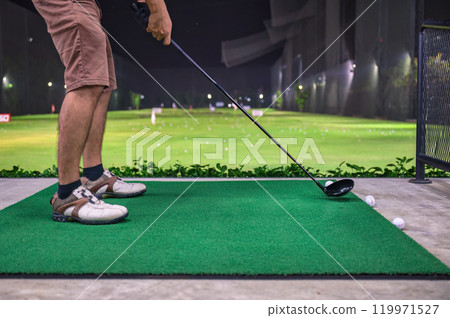 A man practicing with golf swing on golf course at golf driving range 119971527