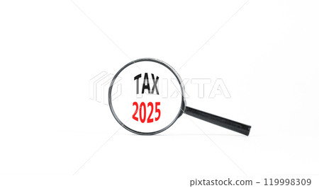 Planning tax 2025 new year symbol. Concept words Tax 2025 on beautiful white paper in magnifying glass. Beautiful white paper background. Business tax 2025 new year concept. Copy space. 119998309