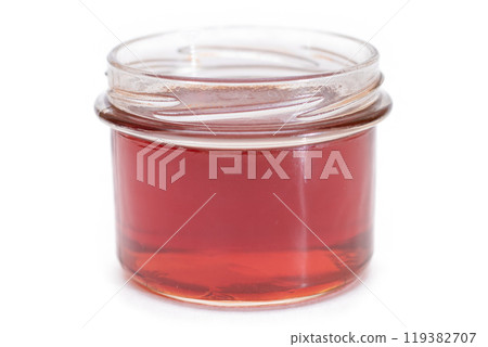 Dark Honey in a Small Glass Jar Isolated 119382707