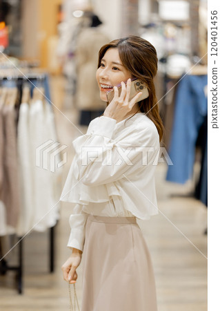 Woman enjoying shopping at an apparel store 120401456