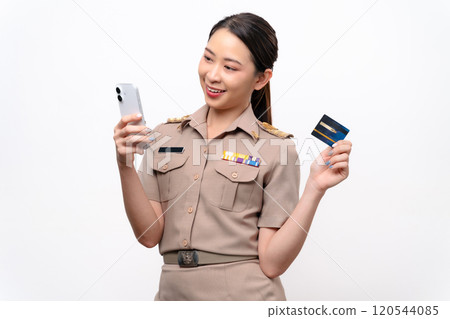 Young Thai Asian Teacher in the uniform is holding the credit card and smart phone. 120544085