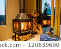 Relaxing by the fireplace 120639690