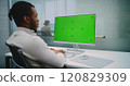 African American financial expert works on personal computer with green screen chromakey 120829309