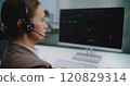 Female financial specialist talks on headset with investor, analyzes share market and stocks on computer 120829314