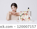 Cosmetics placed on a gift box full of flowers 120007157