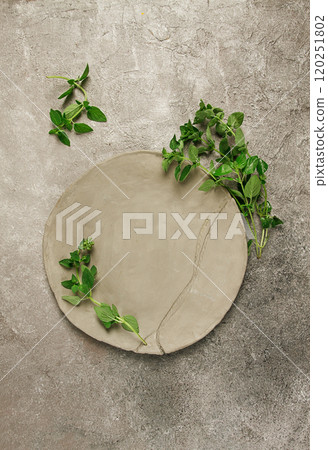 grey clay plate, handmade, with basil branches, top view, food background, food wallpaper for menu, 120251802