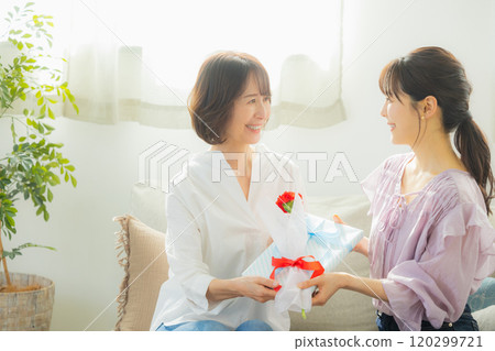 Parents and children giving Mother's Day presents 120299721