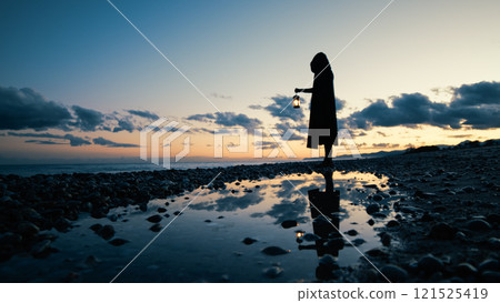 Reflections In The Water Of The Dark Mason With The Lantern  121525419