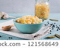 Pickled sauerkraut with carrots in a bowl on the table 121568649