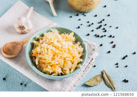 Homemade fermented cabbage in a bowl on the table 121568650