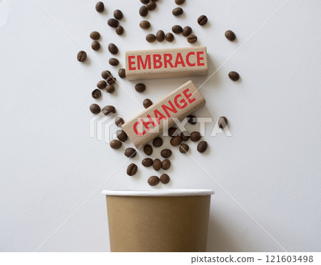 Embrace change symbol. Concept word Embrace change on wooden blocks. Beautiful white background with coffee beans and cup. Business and Embrace change concept. Copy space 121603498