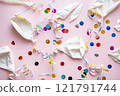 Deflated balloons and colourful confetti scattered on pink. 121791744