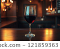 A glass of red wine on a wooden table in a bar or restaurant 121859363