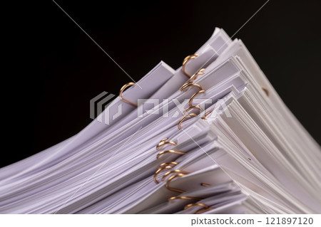 white blank sheets of paper connected by copper staples 121897120