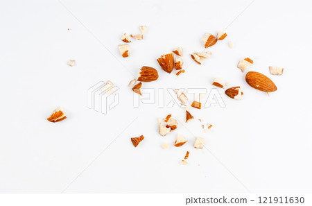 Crushed almonds isolated, nut pieces, sliced scattered almond seeds and cut kernels collection on white background 121911630