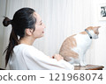 Middle-aged woman with cat 121968074