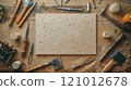 An MDF board on an artist's table, amid carving tools and fine wood dust, showcases meticulous craftsmanship. 121012678