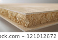 A cross-section of MDF shows a dense core and precise edges, highlighting its consistency for woodworking. 121012672