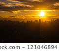 Stunning cityscape of Manila, Philippines with vibrant sunset and dramatic silhouettes created by warm sunlight on clouds and buildings 121046894