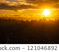 Golden hour in Manila, the sun sets behind the city's skyscrapers, casting a beautiful orange glow on the urban landscape 121046892