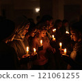 Candlelight prayer gathering with diverse adults in peaceful reflection 121061255