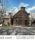 Historic brick building with twin chimneys and blue sky in autumn 121061250