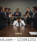 Stressed caucasian male adult surrounded by colleagues in a business meeting 121061252