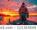 Fisherman in orange workwear standing on a boat  121163648