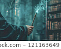 Hand in a black robe holding magical wooden wand 121163649