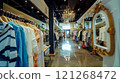 A clothing store filled with lots of clothes and a chandelier 121268472