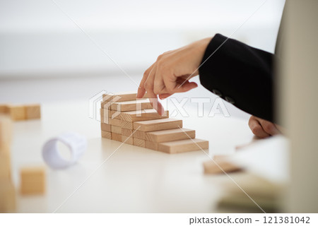 Businesswoman walking her fingers up the conceptual steps 121381042