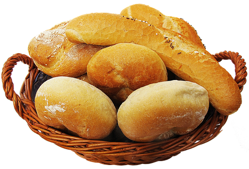 A Basket Of Bread On A Black Background