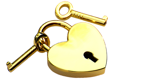 A Gold Heart Shaped Lock With A Key