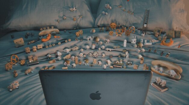 A family of snails gathers around a laptop on a couch.