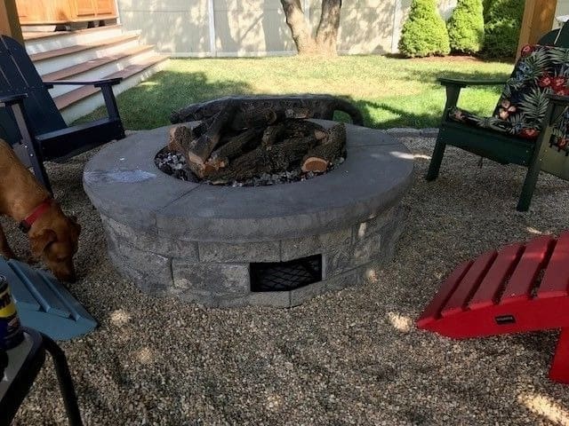 A fire pit with a grill on top of it.