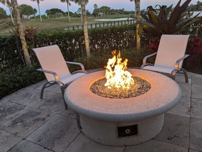 A fire pit sitting on top of a patio.