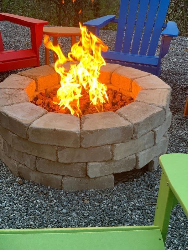 A fire pit with chairs around it