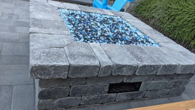 A fire pit with blue rocks in it