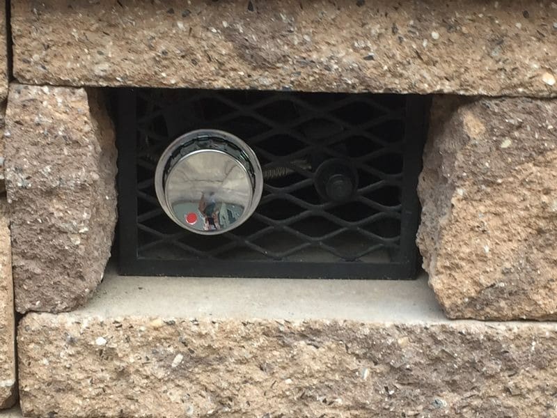 A close up of an air vent with a clock