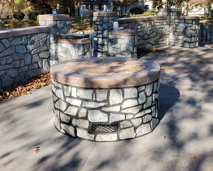 A stone bench in the middle of a park.