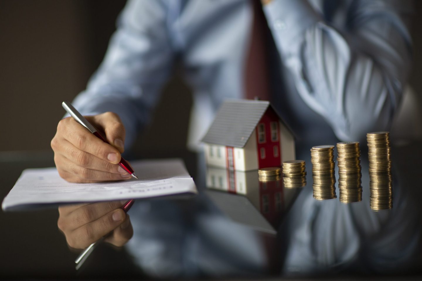 Real estate agent is holding a house model