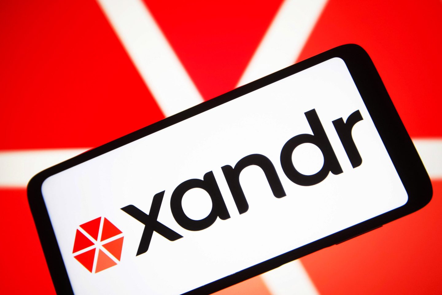 The Xandr Inc. logo is seen on a smartphone screen.