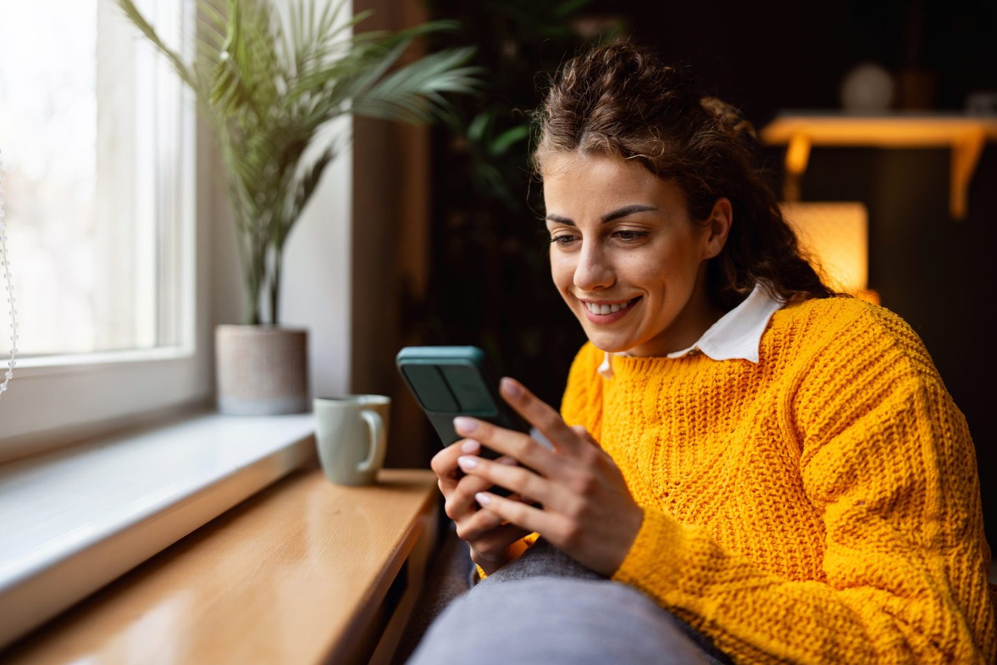 young adult woman reading on her phone