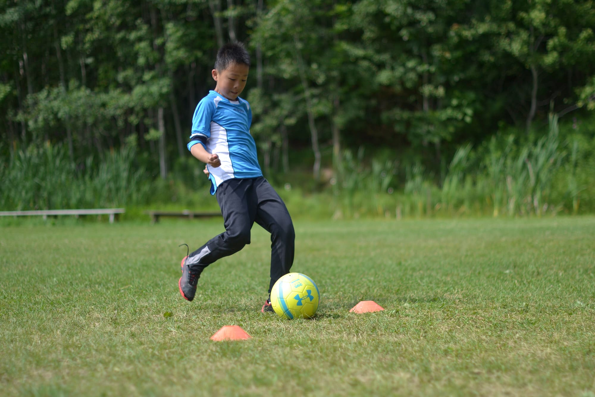 boy kicking soccer ball