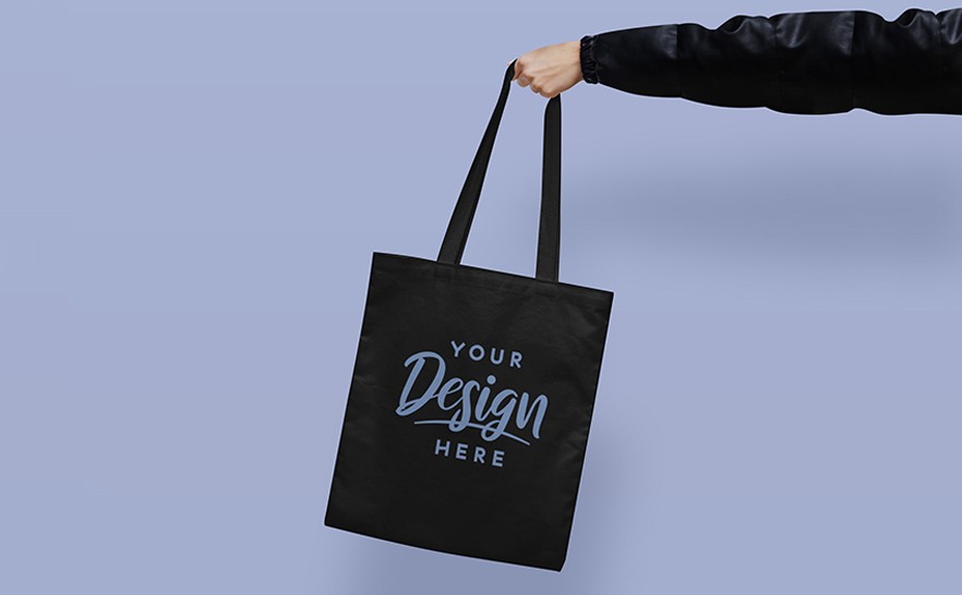 mockup of a hand grabing a tote bag